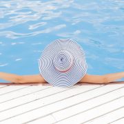 woman relaxing in the pool with a sunhat - let the best rv sewer hose do the work